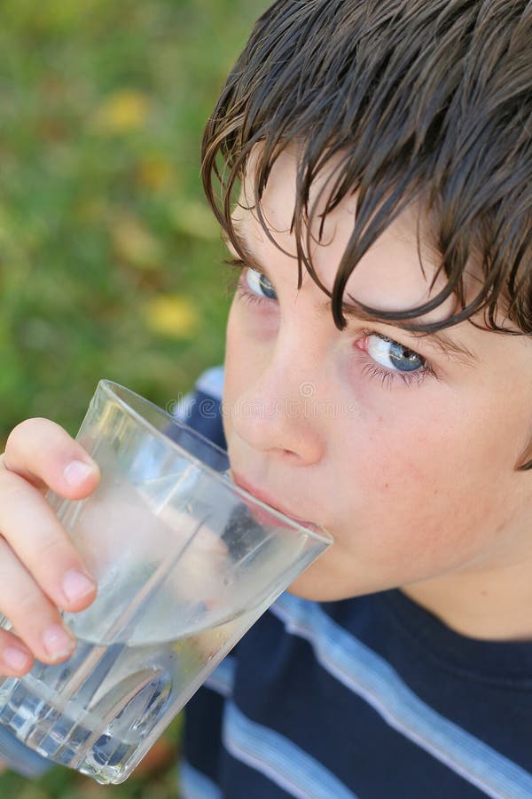 Boy drinking a glass of water