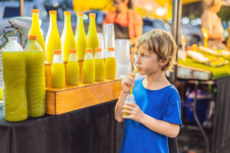 Boy Drinking Sugar Cane Juice on the Asian Market Stock Photo Image