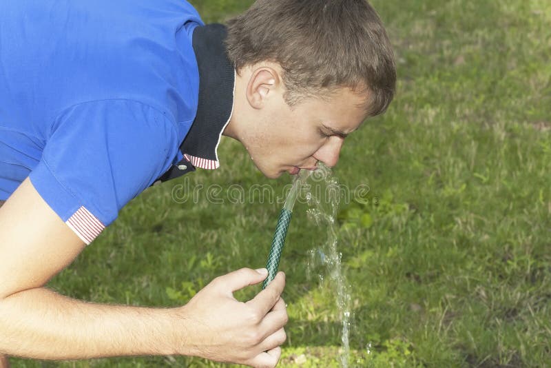 Boy Drinks Water from a Hose Stock Photo Image of drinking, lawn