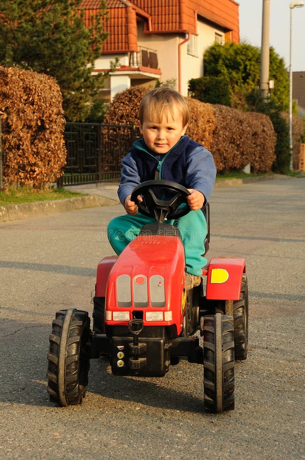 Boy driving tractor