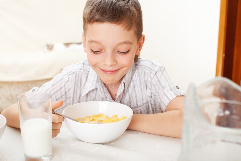 Boy eat breakfast at home stock image. Image of glass - 65208453