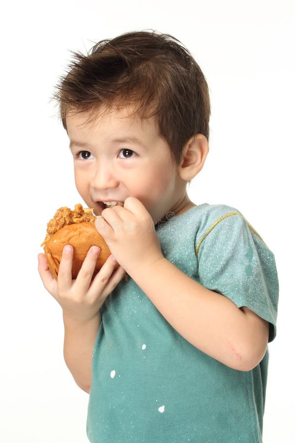 Boy eating a burger stock image. Image of fast, burger 33244133