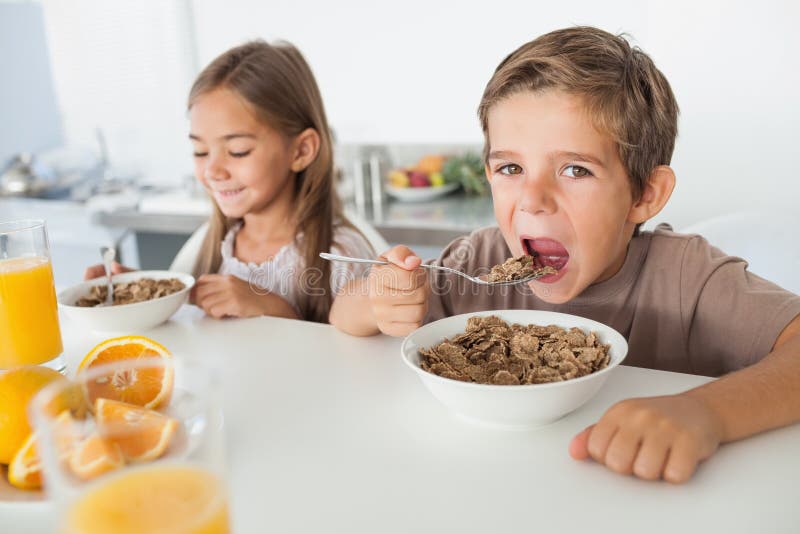 A Boy Is Eating Cereal From A Bowl Stock Photo Image of meal, snack