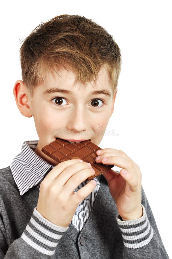 Boy Eating a chocolate bar stock photo. Image of enjoy 23080354