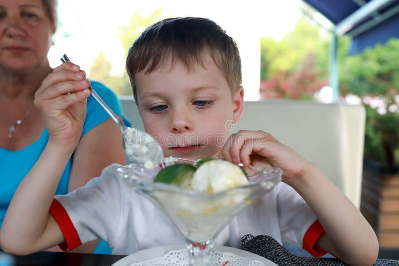 Boy Having an Ice Cream in a Restaurant Stock Image - Image of vacation ...