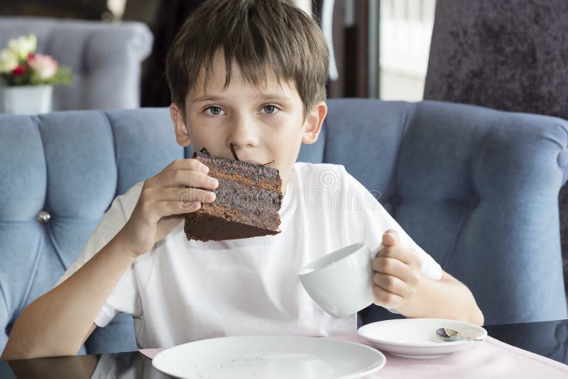 The Boy is Eating a Large Piece of Cake Stock Photo Image of