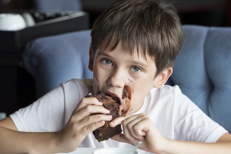 The Boy is Eating a Large Piece of Cake Stock Image - Image of ...