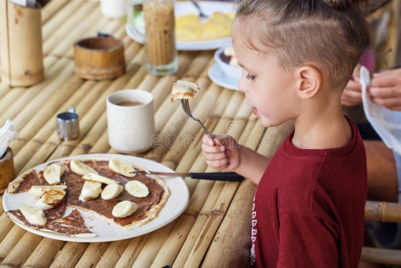Boy Eating Pancake with Banana and Chocolate Stock Photo Image of