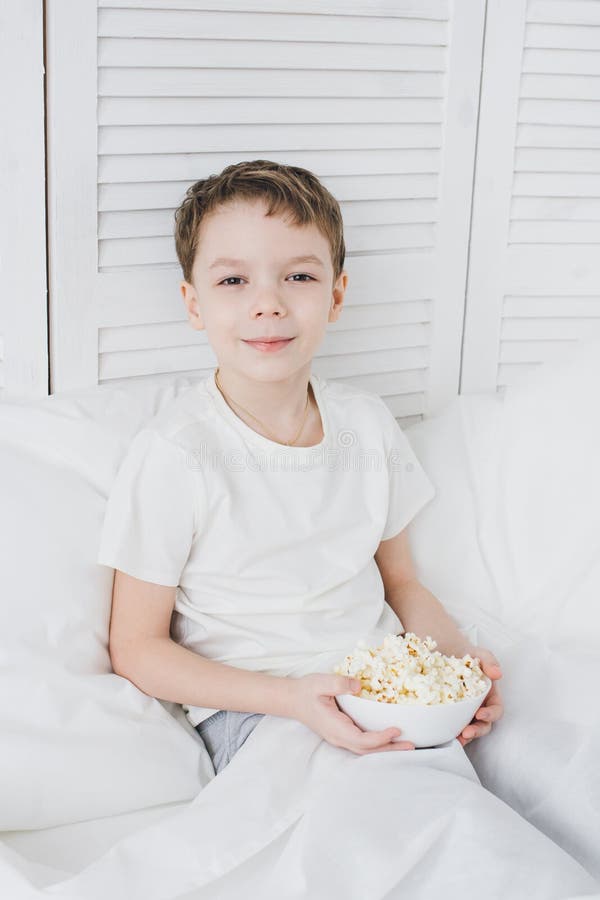 Boy Eating Popcorn Sitting in Bed Stock Photo Image of cute, watching