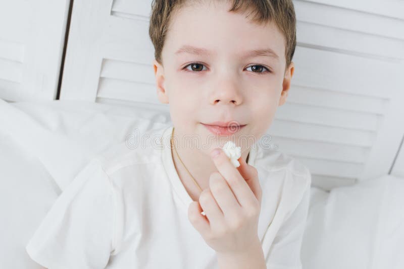 Boy Eating Popcorn Sitting in Bed Stock Photo Image of child, remote