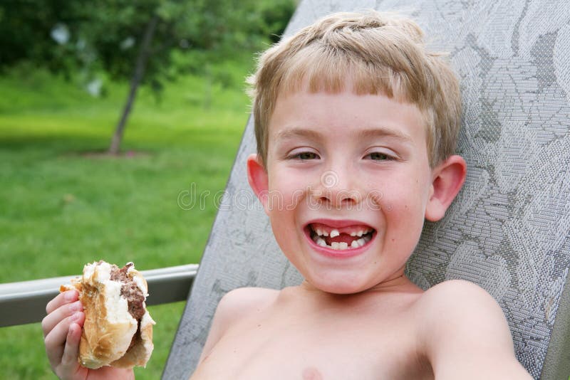 Boy eating with a very loose front tooth royalty free stock images Boy eating with a very loose front tooth royalty free stock images