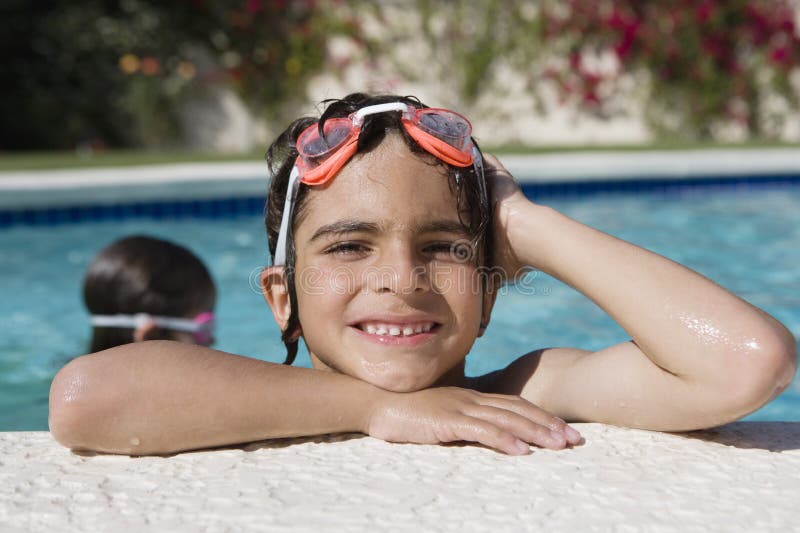 Boy At The Edge Of Swimming Pool stock images
