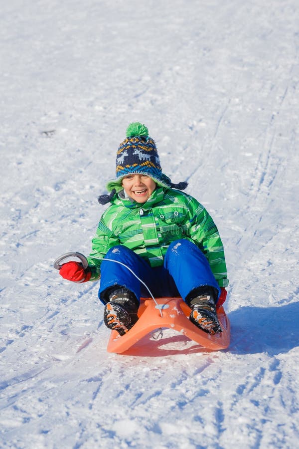 Boy enjoying a sleigh ride stock photo. Image of nature - 63500492