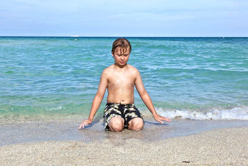 Boy enjoys the clear water in the ocean