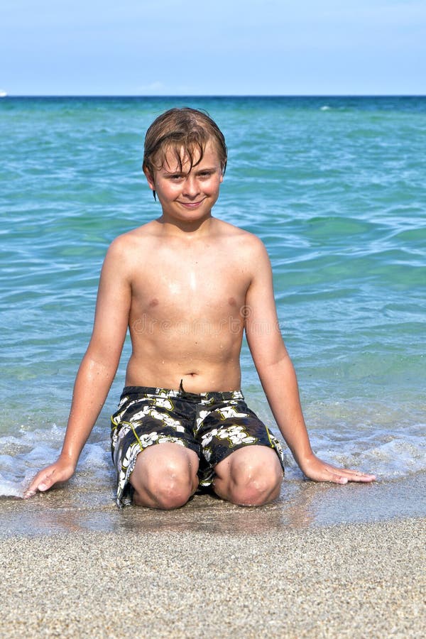 Boy enjoys the clear water in the ocean