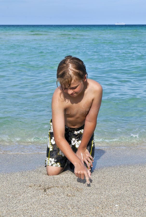 Boy enjoys the clear water in the ocean