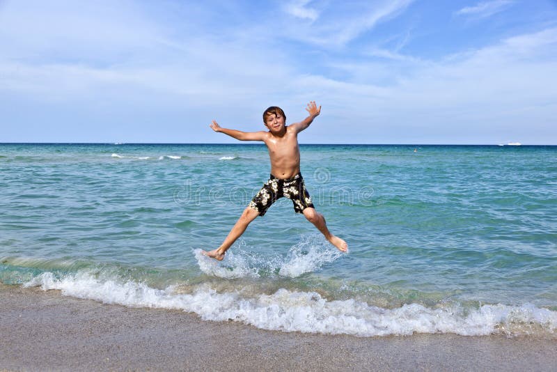 Boy enjoys the clear water in the ocean