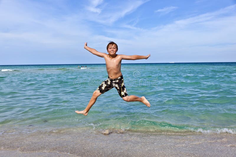 Boy enjoys the clear water in the ocean