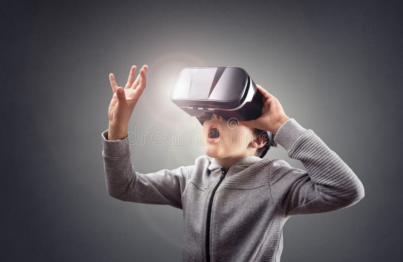 Boy experiencing using a virtual reality headset royalty free stock image