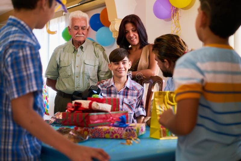 Boy With Family And Friends Celebrating Birthday  Party  