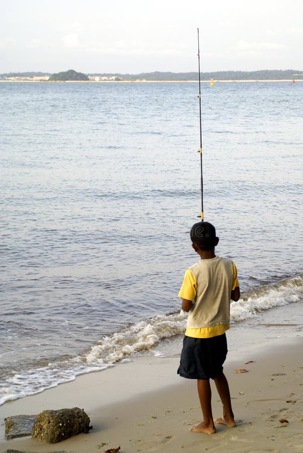 Boy fishing at beach