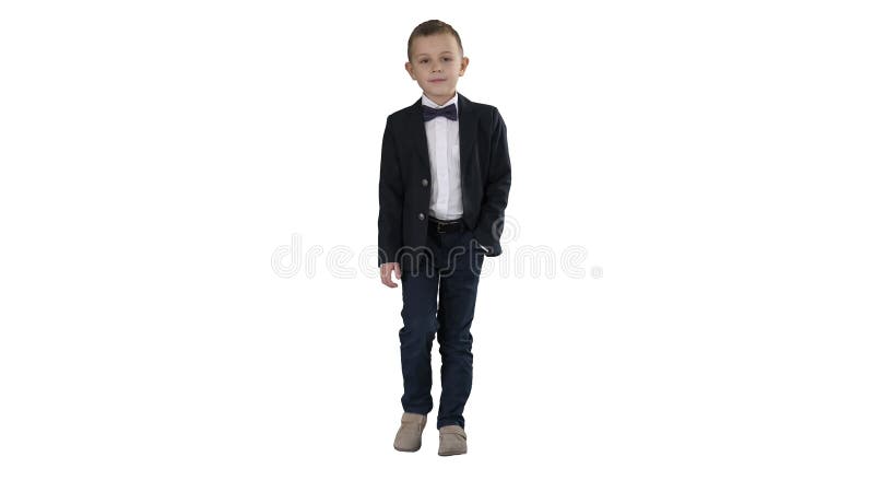 Boy in formal costume walking with a hand in pocket on white background.