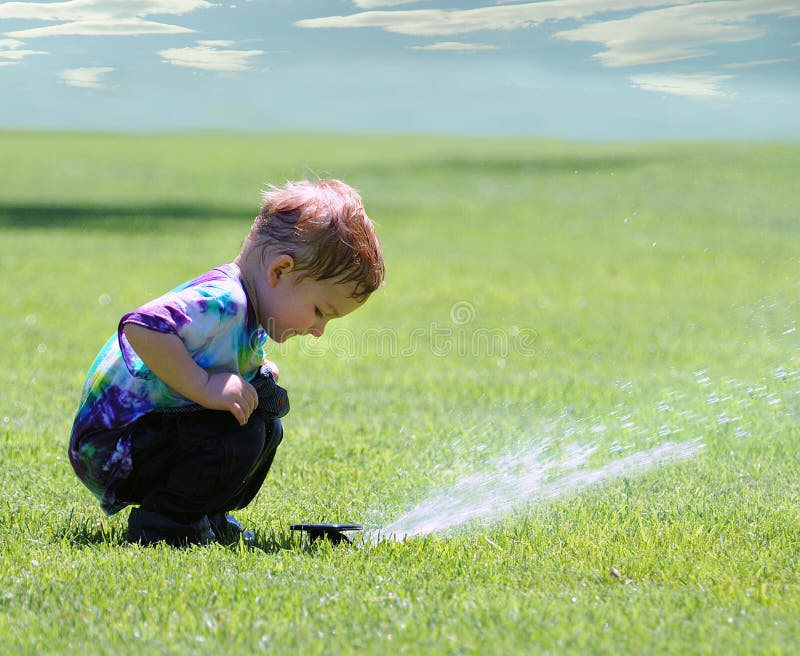 Boy and garden sprinkler