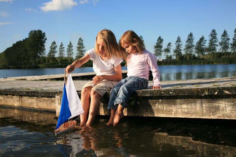 Boy and girl with boat stock image. Image of summer, dream 15884093