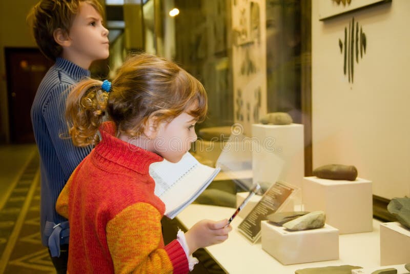 Boy and girl at excursion in historical museum