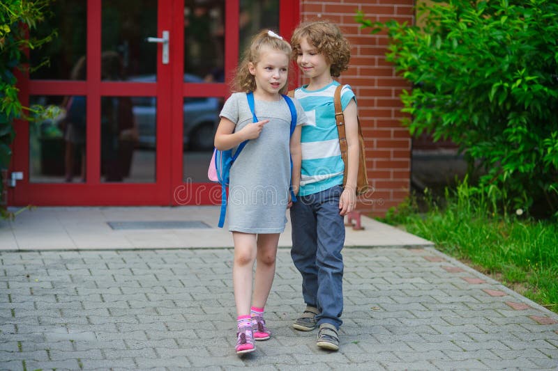 Boy and girl go to school having joined hands. stock images Boy and girl go to school having joined hands. stock images