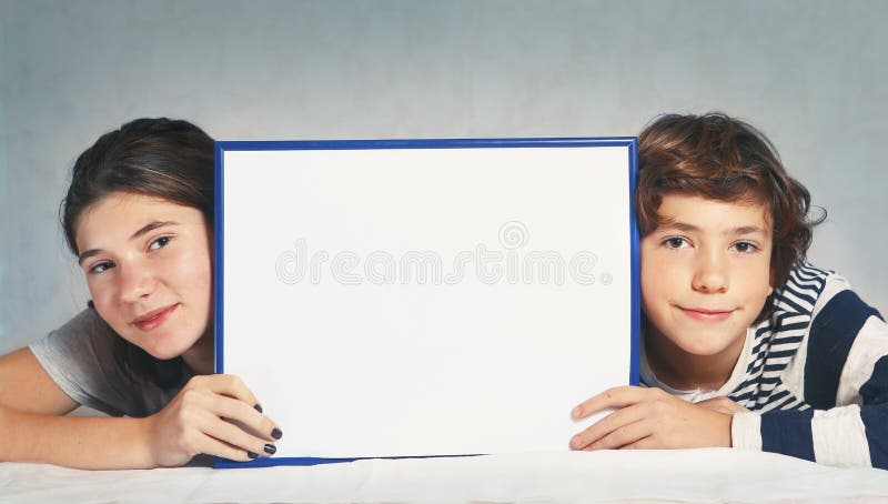 Boy and girl hold blank rectangular frame