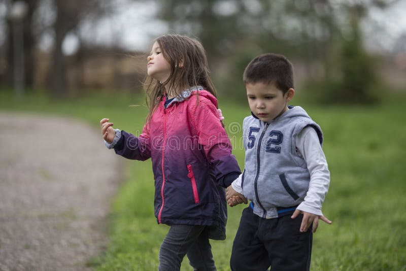 Boy and Girl holding hands stock photo. Image of happiness - 117302442