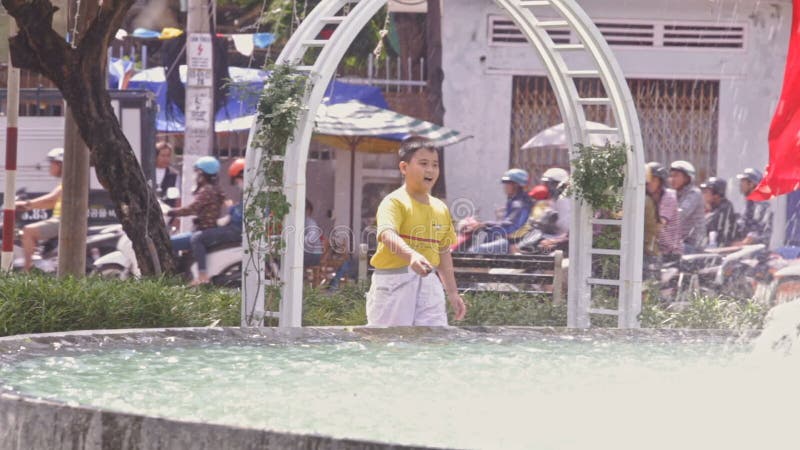 Boy Girl Play at Big Street Fountain on Sunny Day