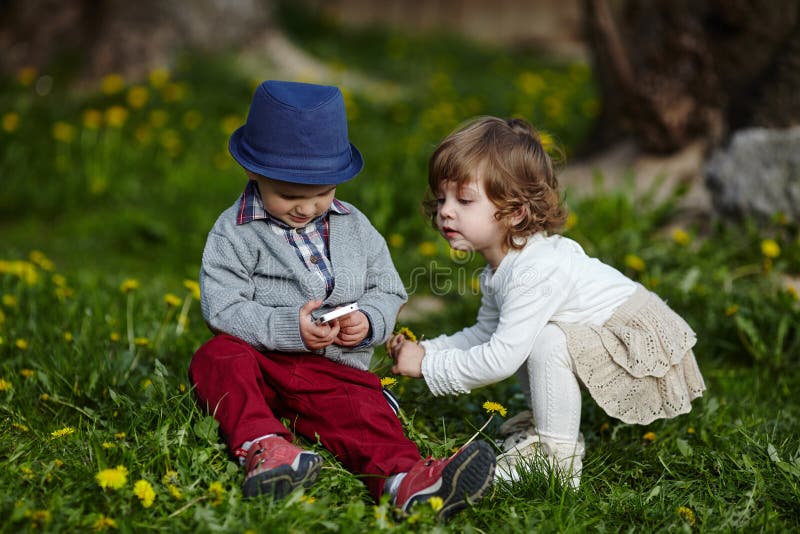 Boy and girl playing with mobile phone