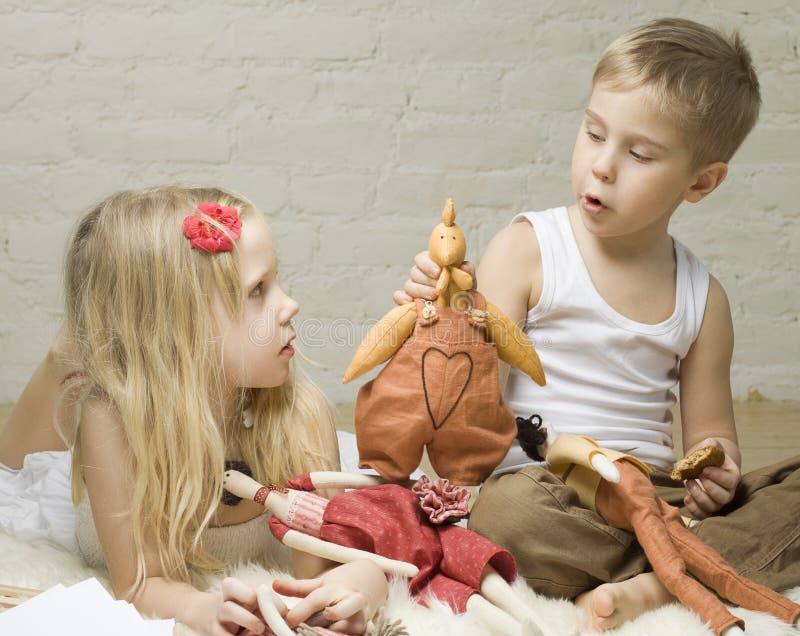 Boy and girl playing with stuffed animals