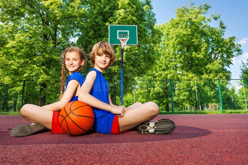 Boy and girl sit with backs close on playground royalty free stock photo Boy and girl sit with backs close on playground royalty free stock photo