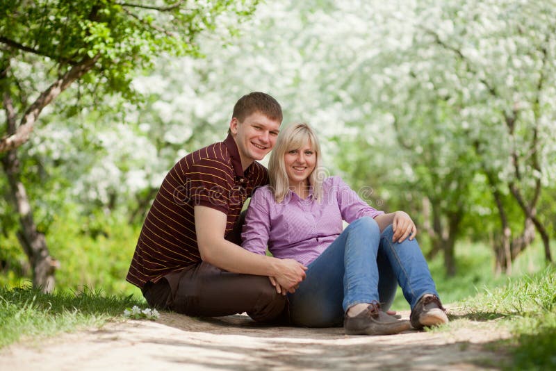 Boy and girl sitting together stock images