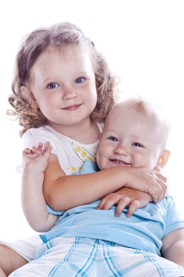 Boy and girl sitting on white