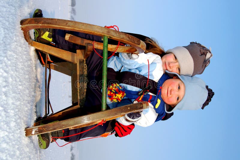 boy and girl on a sleigh