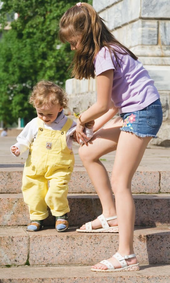 Boy and girl on a stair in a city park