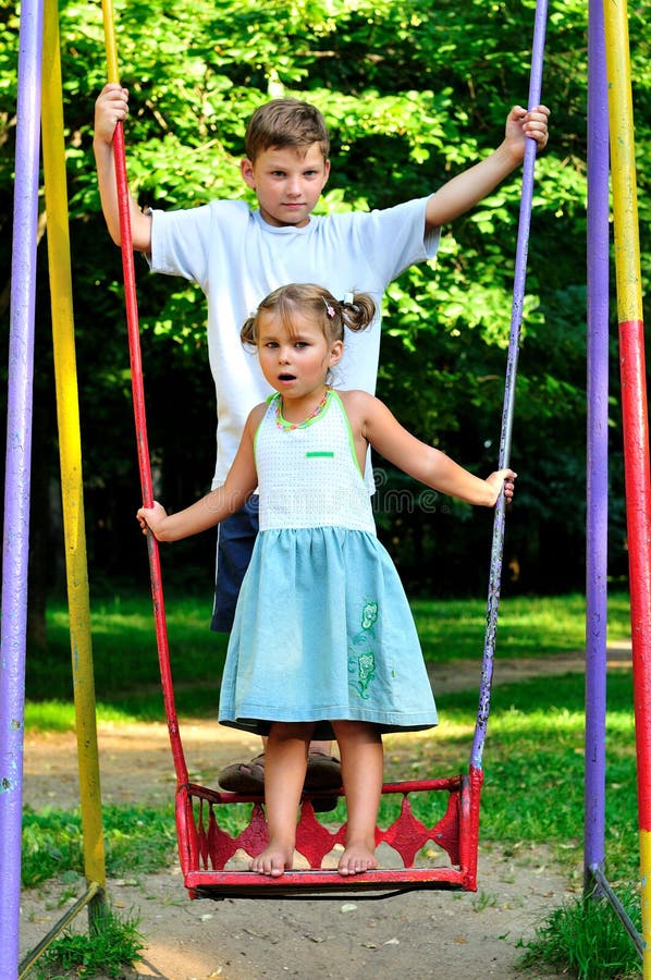 The boy and the girl on a swing