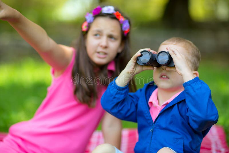 Boy and girl using binocular stock photos