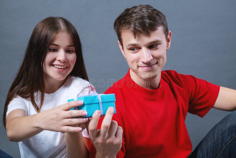Boy gives a girl a gift stock photo. Image of beautiful 162610850