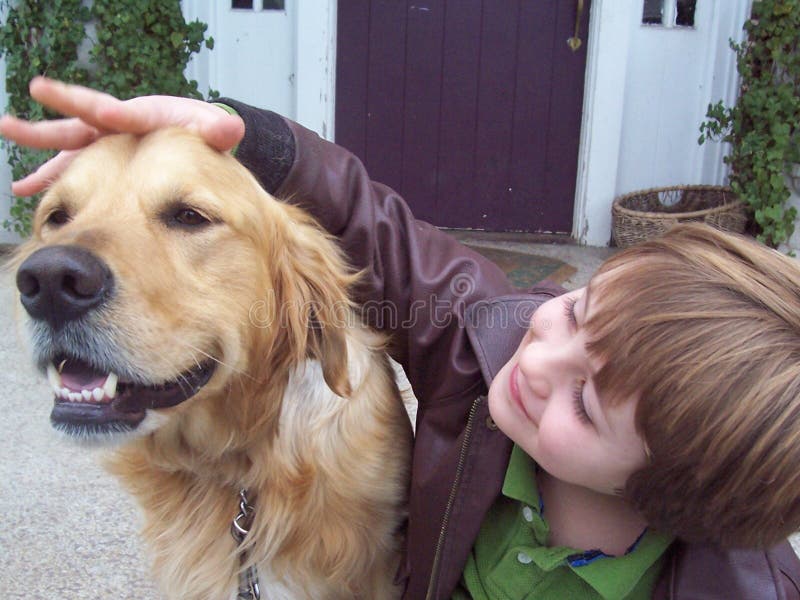 Boy and golden retriever on porch