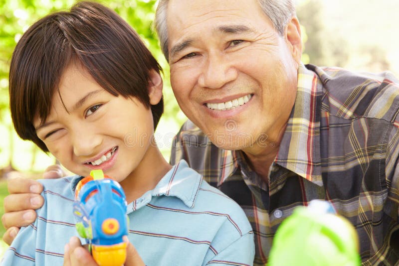 Boy and grandfather with water pistols