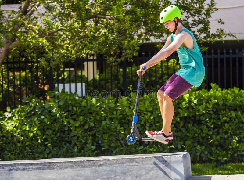 Boy has fun riding his push scooter