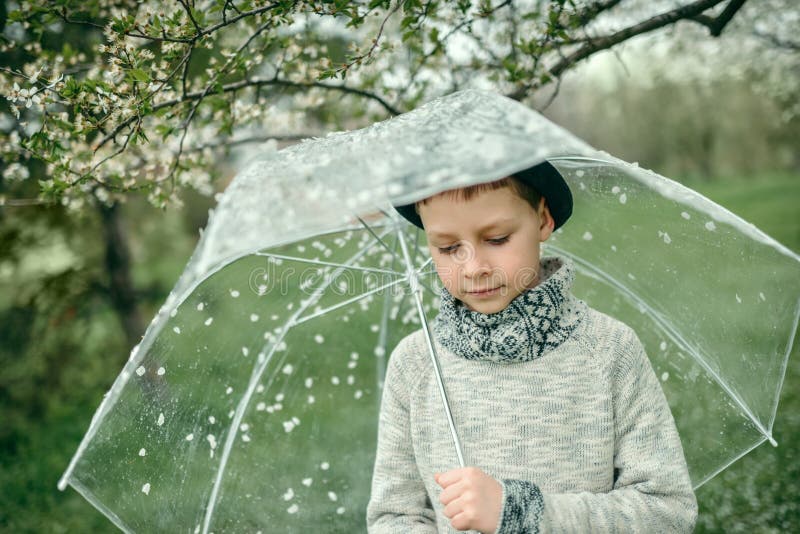 Boy in a hat with an umbrella