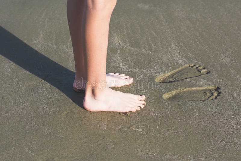 The Boy is Having Fun and Leaves Footprints on the Sand. Stock Photo Image of teen, model