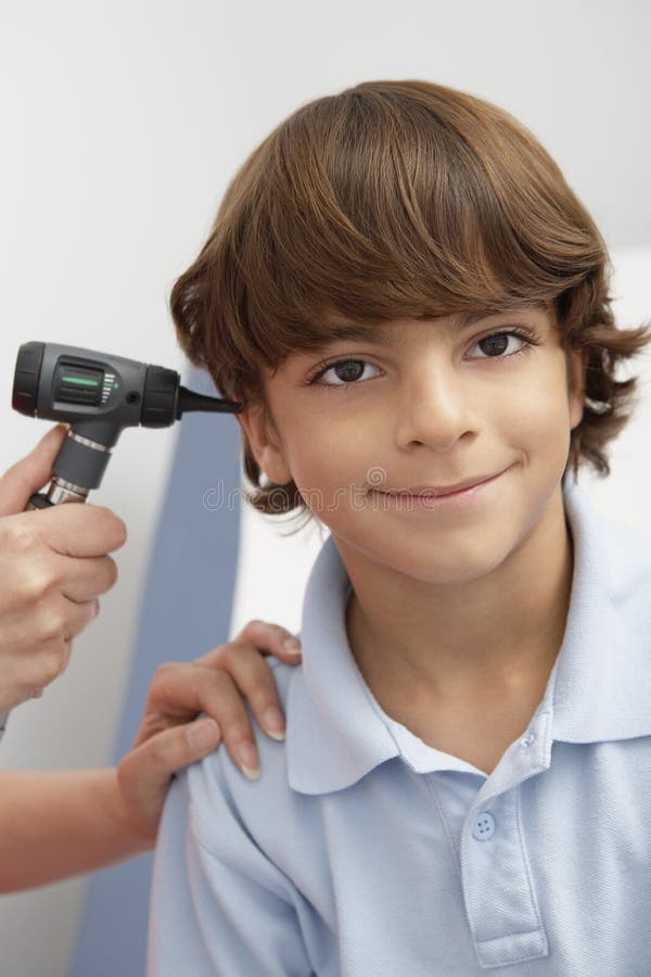 Doctor Examining Boy`s Ear stock image. Image of otolaryngology 86364301