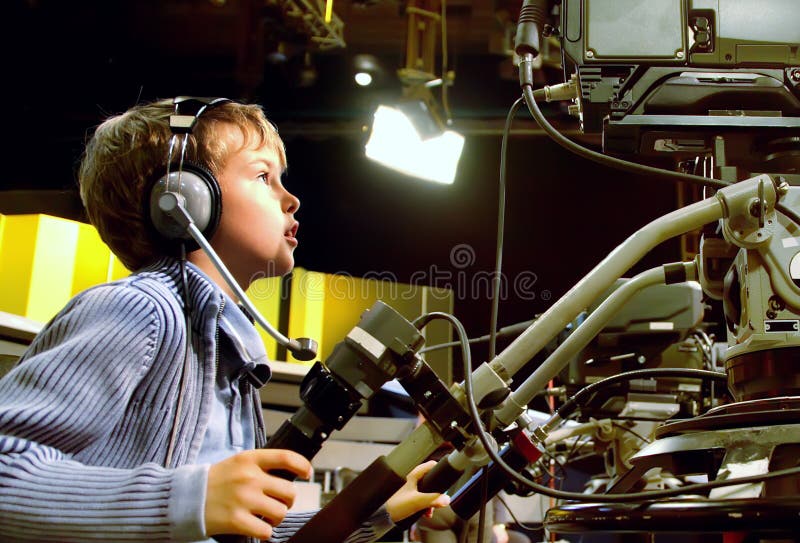 Boy with headphones looks to camera